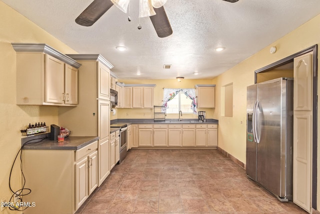1302 E Forge Ave, Mesa, AZ 85204 - kitchen featuring stainless steel appliances, dark countertops, a sink, a textured ceiling, and ceiling fan