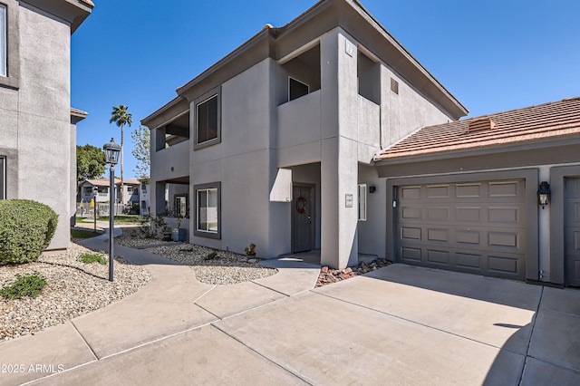 view of front of property featuring concrete driveway and stucco siding