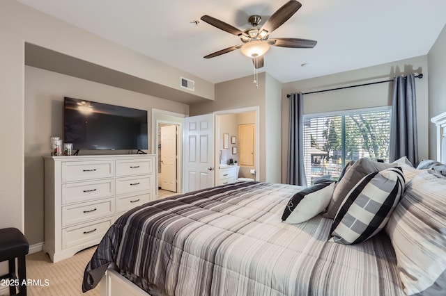 bedroom with visible vents, light carpet, and a ceiling fan