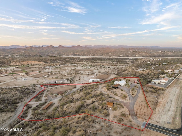 birds eye view of property featuring a desert view and a mountain view