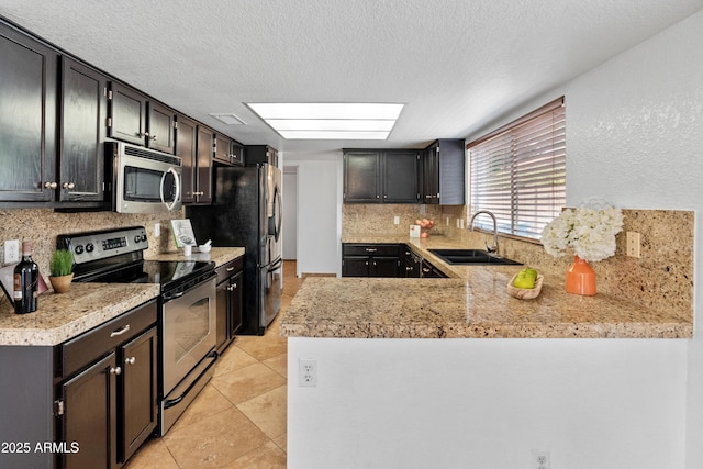 20809 N 1st Ave, Phoenix, AZ 85027 - kitchen featuring stainless steel appliances, a sink, decorative backsplash, light countertops, and a textured ceiling
