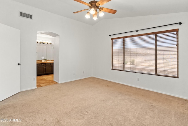 20809 N 1st Ave, Phoenix, AZ 85027 - empty room with arched walkways, light colored carpet, a ceiling fan, lofted ceiling, and baseboards