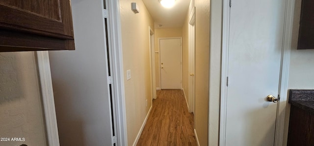 corridor with light wood-type flooring