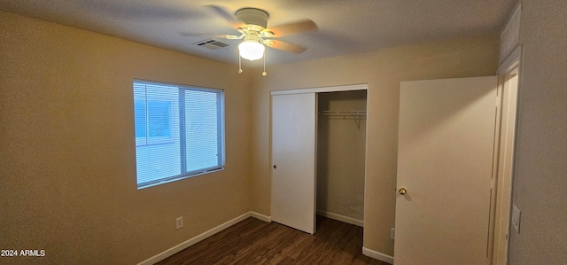 unfurnished bedroom with dark hardwood / wood-style flooring, ceiling fan, and a closet