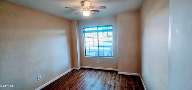 empty room featuring dark hardwood / wood-style flooring and ceiling fan