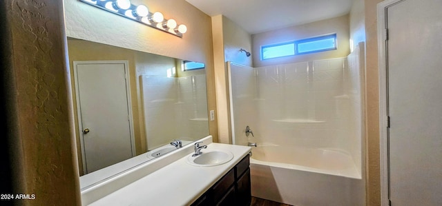 bathroom featuring vanity and  shower combination