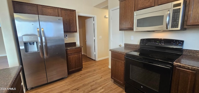 kitchen with light hardwood / wood-style flooring, stainless steel appliances, and dark brown cabinets