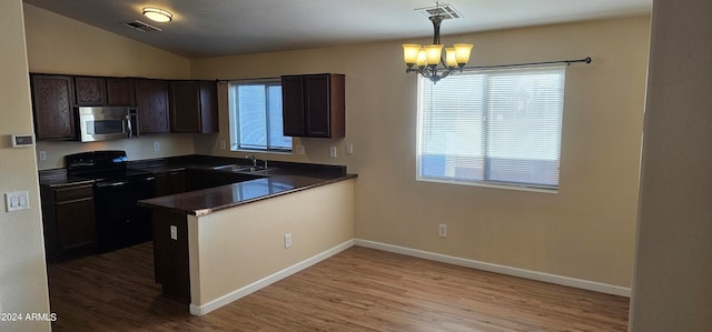 kitchen featuring pendant lighting, hardwood / wood-style floors, black electric range oven, sink, and a notable chandelier