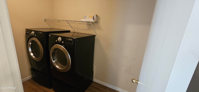 laundry room with dark hardwood / wood-style floors and washer and dryer