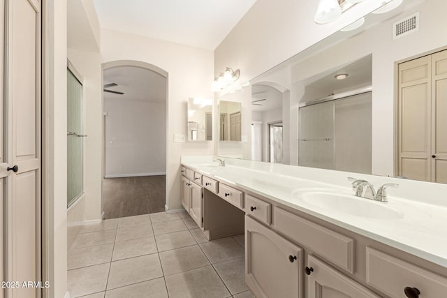 bathroom with vanity, tile patterned flooring, ceiling fan, and walk in shower