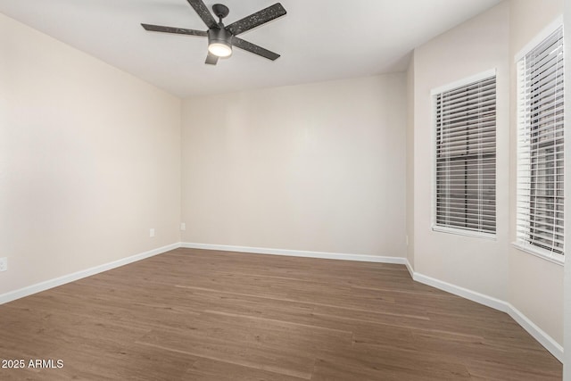 unfurnished room featuring ceiling fan and dark hardwood / wood-style floors