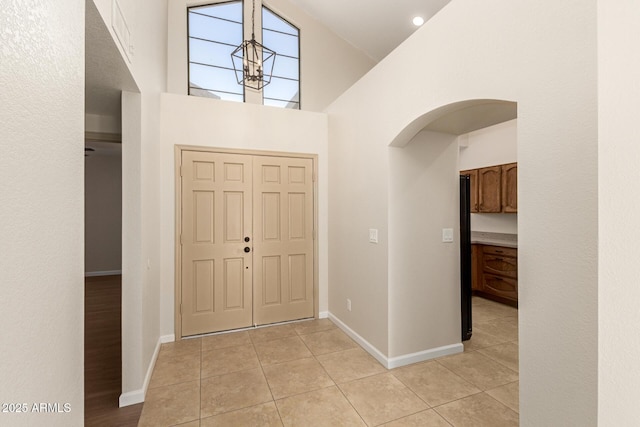 tiled entryway with high vaulted ceiling