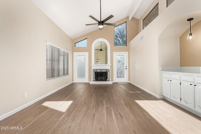 unfurnished living room with ceiling fan, light hardwood / wood-style flooring, and high vaulted ceiling