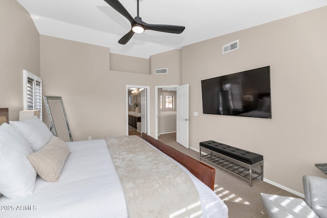 carpeted bedroom featuring a ceiling fan, visible vents, vaulted ceiling, and baseboards