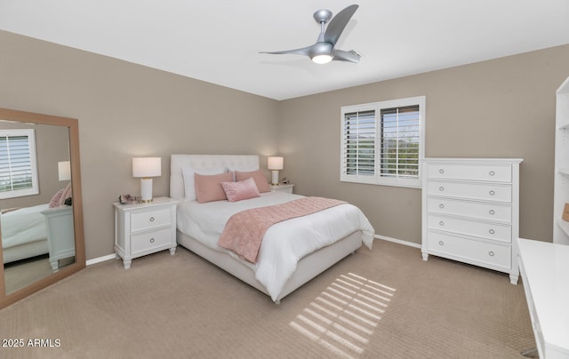 bedroom with light carpet, ceiling fan, and baseboards