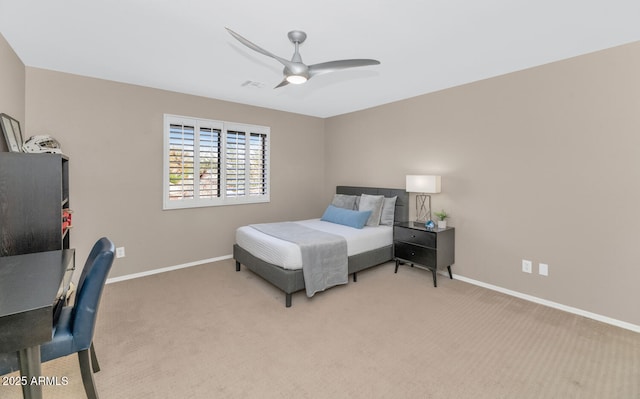 bedroom featuring a ceiling fan, light carpet, and baseboards