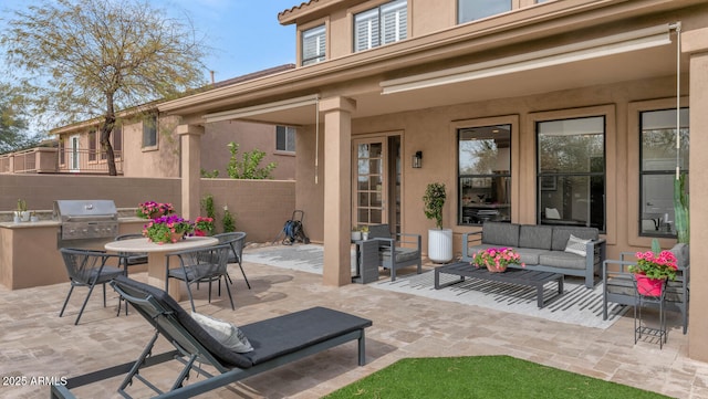 view of patio with outdoor dining area, outdoor lounge area, fence, and grilling area