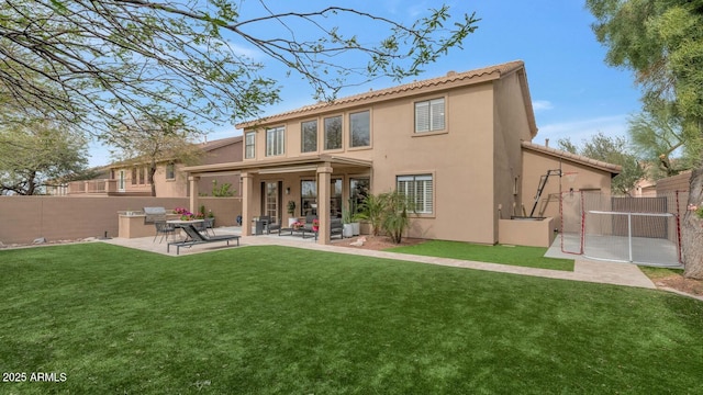 back of house featuring a patio, a lawn, fence, and stucco siding