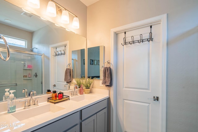 bathroom with a shower with door and vanity