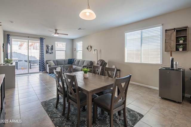 dining space with light tile patterned floors and ceiling fan