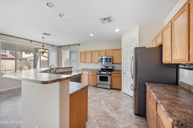 kitchen with visible vents, recessed lighting, stainless steel appliances, and a kitchen island with sink