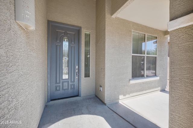 entrance to property with stucco siding