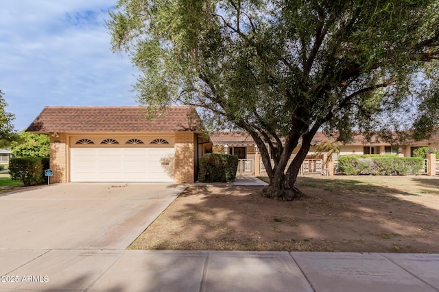 single story home featuring a garage, mansard roof, concrete driveway, and brick siding