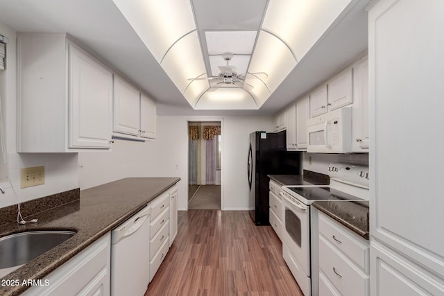 kitchen with ceiling fan, white appliances, a sink, white cabinetry, and a raised ceiling