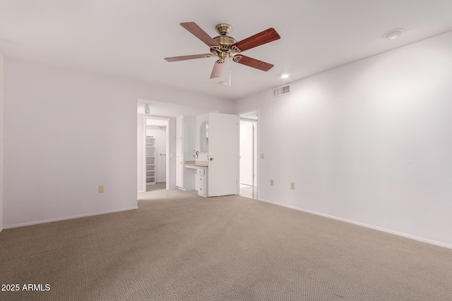 unfurnished room with light carpet, ceiling fan, visible vents, and baseboards