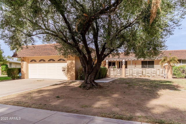 single story home with brick siding, driveway, and an attached garage