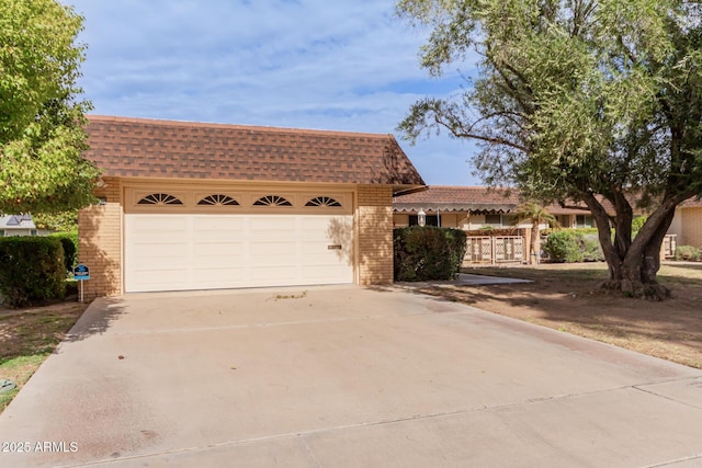 single story home with a shingled roof, brick siding, and mansard roof