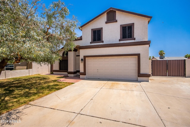 front of property with a garage and a front lawn