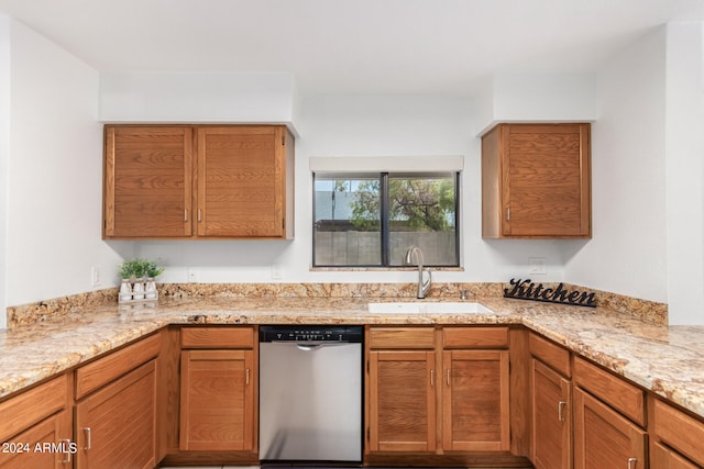 kitchen with sink, dishwasher, and light stone countertops