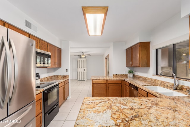 kitchen featuring light tile patterned flooring, kitchen peninsula, ceiling fan, stainless steel appliances, and sink