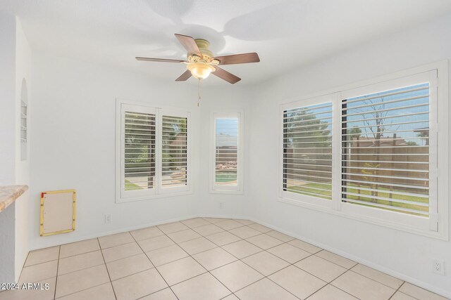 tiled empty room with ceiling fan