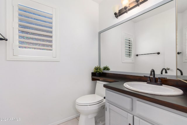 bathroom with vanity, toilet, and tile patterned floors