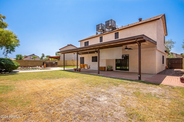 back of house with a patio area, ceiling fan, and a lawn