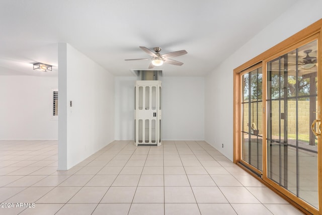 tiled spare room featuring ceiling fan