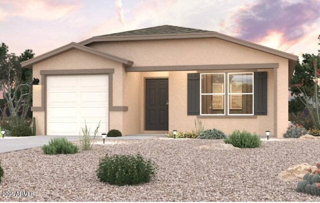 view of front facade with a garage, concrete driveway, and stucco siding