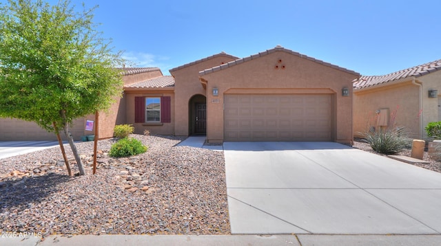 4975 W Gulch Dr, Eloy, AZ 85131 - mediterranean / spanish-style house with concrete driveway, stucco siding, a tiled roof, and an attached garage