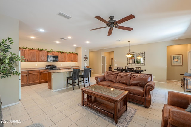 4975 W Gulch Dr, Eloy, AZ 85131 - living room with recessed lighting, light tile patterned floors, visible vents, and a ceiling fan
