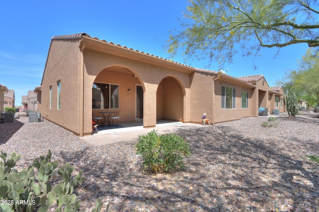 4975 W Gulch Dr, Eloy, AZ 85131 - rear view of property featuring a patio area, a tile roof, central air condition unit, and stucco siding
