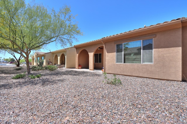 4975 W Gulch Dr, Eloy, AZ 85131 - view of front of house featuring a tiled roof, a patio area, and stucco siding