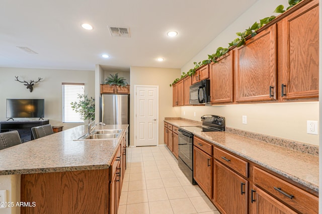 4975 W Gulch Dr, Eloy, AZ 85131 - kitchen featuring visible vents, a sink, brown cabinetry, black appliances, and recessed lighting