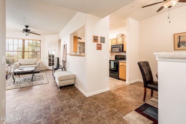 living room featuring ceiling fan and lofted ceiling