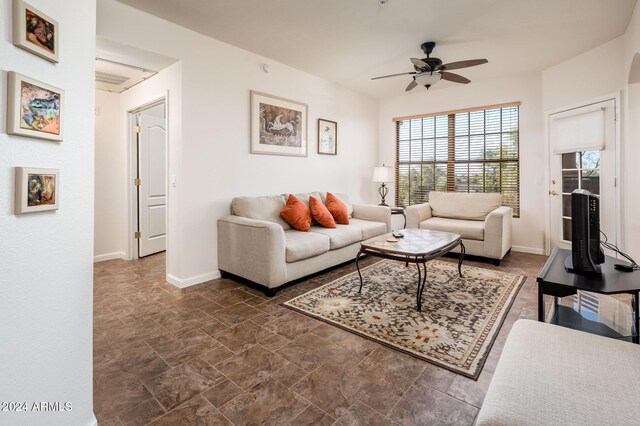 14950 W Mountain View Blvd Unit 1305, Surprise, AZ 85374 - living room with a ceiling fan, baseboards, and dark stone finish flooring