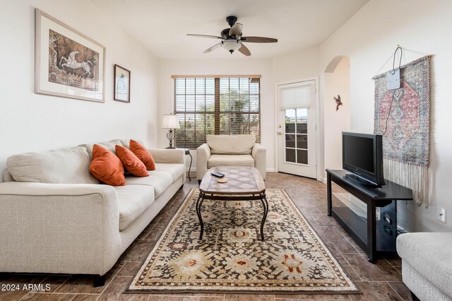 14950 W Mountain View Blvd Unit 1305, Surprise, AZ 85374 - living room featuring arched walkways, a ceiling fan, and dark wood-type flooring
