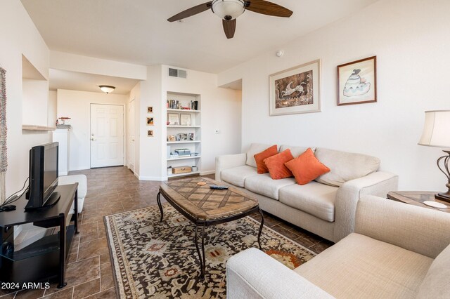 14950 W Mountain View Blvd Unit 1305, Surprise, AZ 85374 - living area featuring ceiling fan, built in shelves, and baseboards