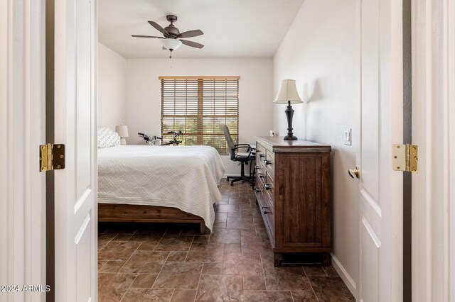 14950 W Mountain View Blvd Unit 1305, Surprise, AZ 85374 - bedroom featuring dark stone finish flooring, baseboards, and ceiling fan
