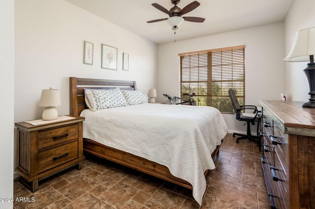 14950 W Mountain View Blvd Unit 1305, Surprise, AZ 85374 - bedroom with dark stone finish floors, ceiling fan, and baseboards